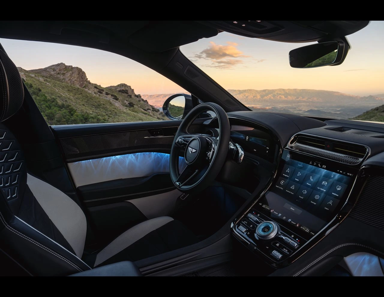 Bentley Torcal cabin with a quilted leather seat, steering wheel, center touchscreen and blue ambient door lighting